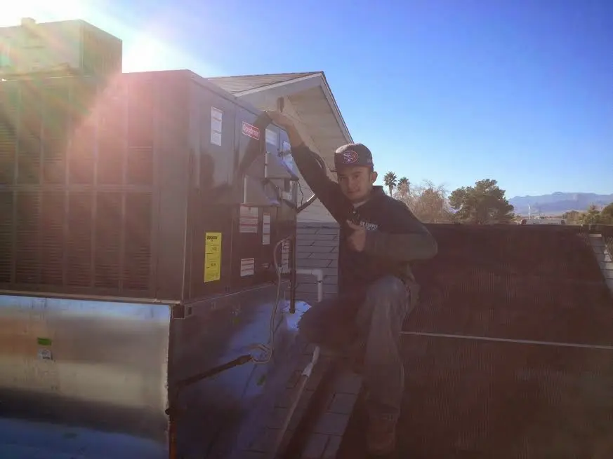 HVAC technician performing Air Duct Cleaning on a rooftop unit in Atlantic